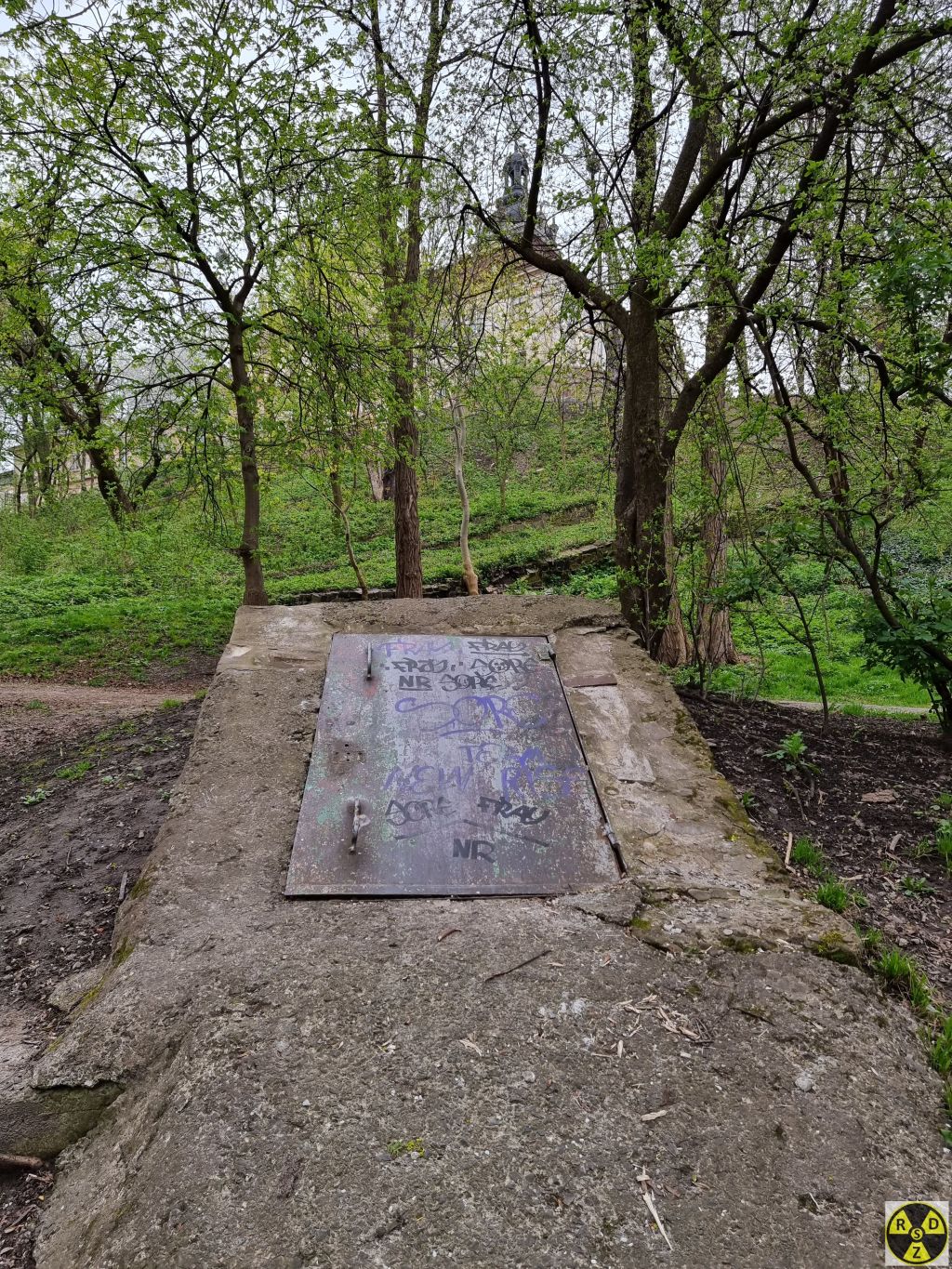 Головний вхід у Бомбосховище та церква Юра на задньому плані